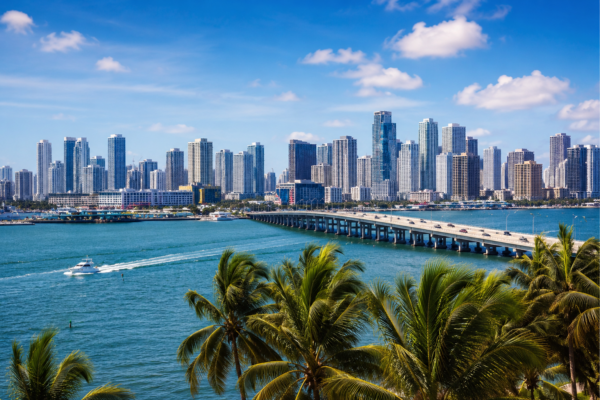 Realistic photo of the Miami skyline, Biscayne Bay, palm trees, and bridge for a federal defense attorney blog post.
