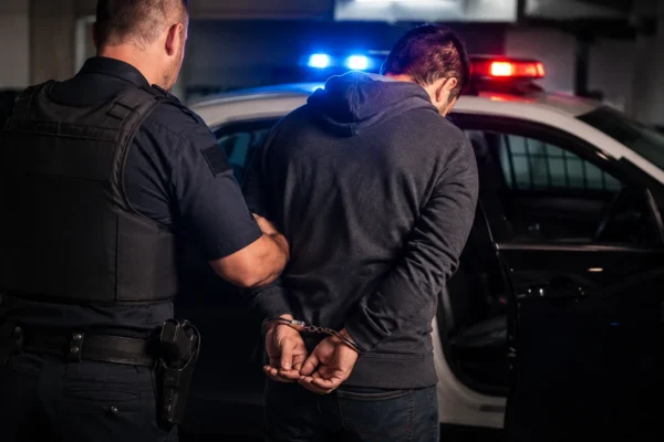 Person being arrested by police in Miami for a criminal defense article